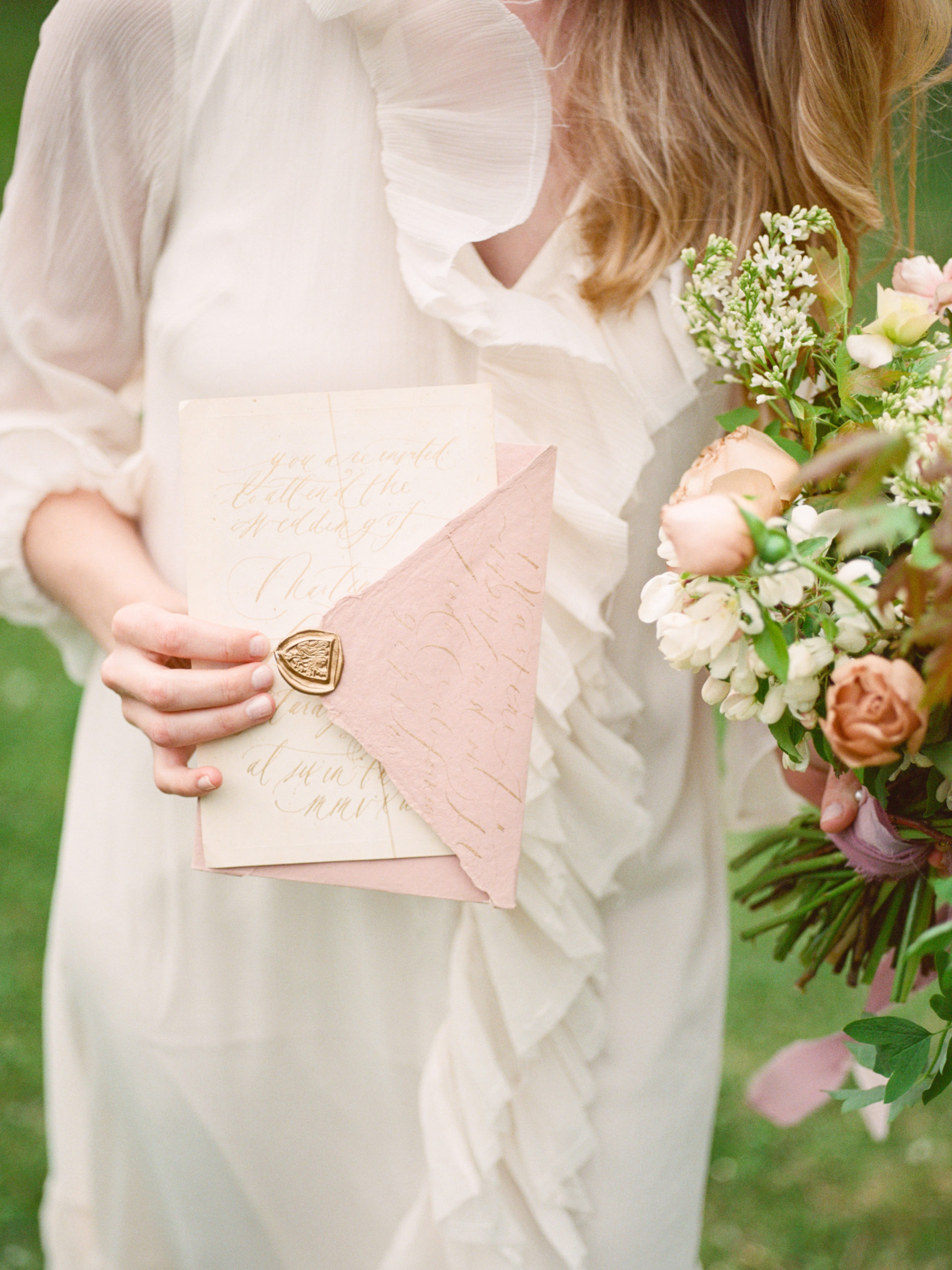Ruffled cream romantic wedding dress with garden rose bouquet by Studio Fleurette