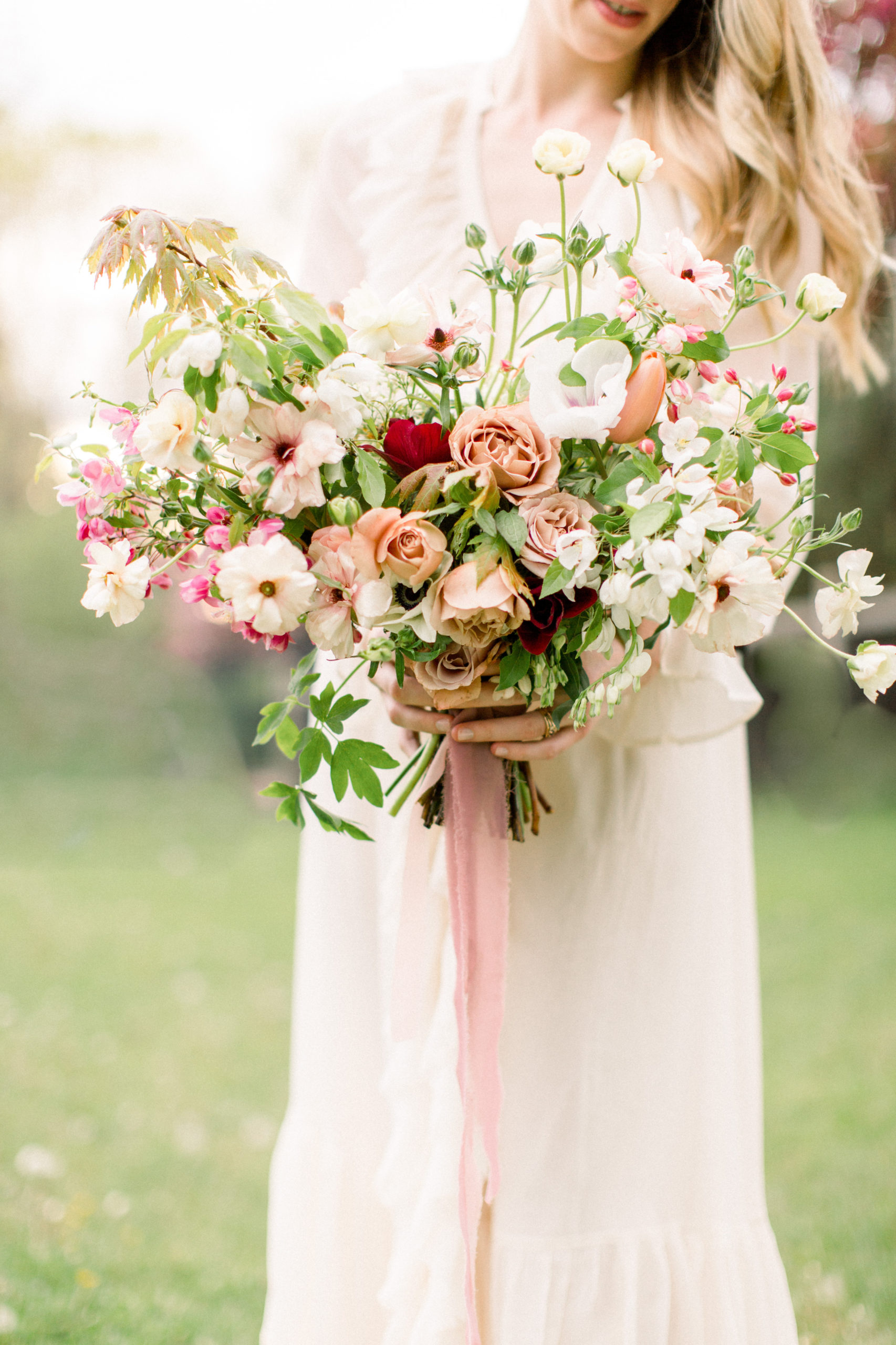 spring bridal bouquet by Studio fleurette with mauve garden roses, burgundy anemone, butterfly ranunculus and appleblossoms.