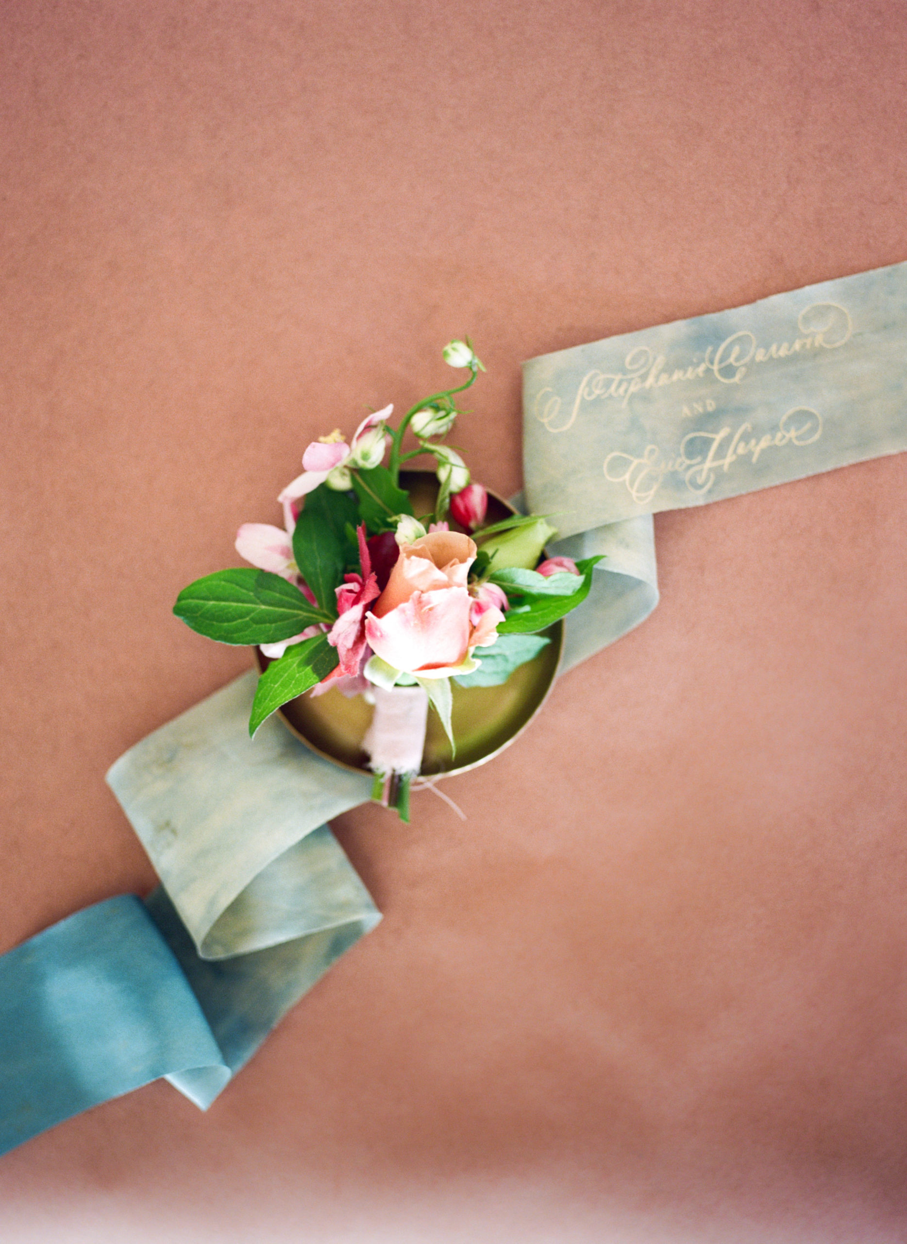Styled spring garden rose boutonniere on small gold tray by Studio Fleurette in Minneapolis Minnesota.