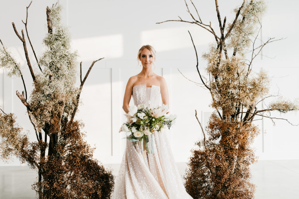 bride with rustic arch for winter weddings