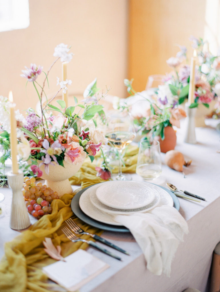 floral centerpieces with fruit styling on lilac colored linen